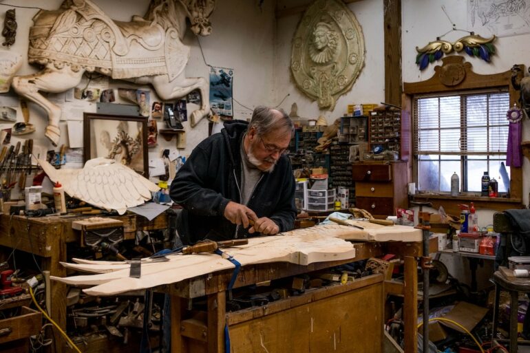 Image of Joe Leonard working on a carving at his workshop table
