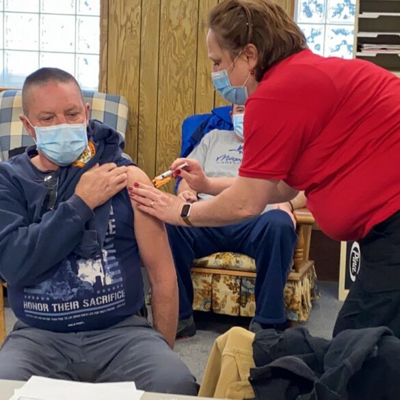 Image of a man receiving a shot for the Covid-19 vaccine