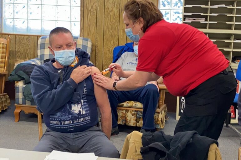 Image of a man receiving a shot for the Covid-19 vaccine