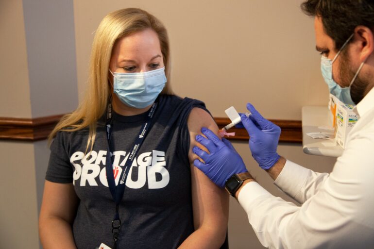 Image of a woman receiving the Covid-19 vaccine