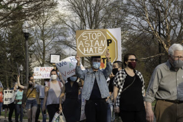 Image of demonstrators marching against anti-Asian racism