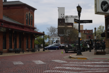 Photo of a red brick road intersection in downtown Kent. The street signs on the corner read franklin ave and Erie Street